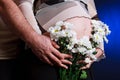 Pregnant woman belly closeup with flowers Royalty Free Stock Photo