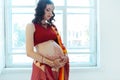 The pregnant woman belly with henna tattoo