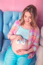 Pregnant woman belly holding baby booties Royalty Free Stock Photo