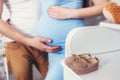 Pregnant woman belly holding baby booties Royalty Free Stock Photo