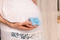 Pregnant woman with belly, man hugging big tummy, holding knitted shoes for the baby Royalty Free Stock Photo