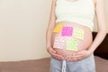 Pregnant woman belly with question mark. Pregnancy and thinking problem Royalty Free Stock Photo