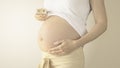 Pregnant woman belly with the week number 28 Royalty Free Stock Photo