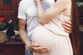 Pregnant woman with big belly bump hugging with her husband. hap Royalty Free Stock Photo