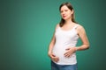 Pregnant woman with big belly and happy face expression, expecting a baby to birth.