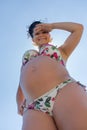 Pregnant woman in bikini posing against sky Royalty Free Stock Photo