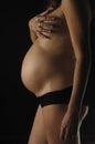 Pregnant woman with black background Royalty Free Stock Photo