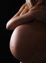 Pregnant woman on black background.