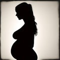 Pregnant woman black silhouette on beige background, the beauty of expecting a child Royalty Free Stock Photo