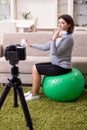 Pregnant woman blogger doing physical exercises Royalty Free Stock Photo