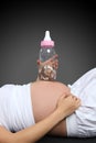 Pregnant Woman with Bottle Bank Royalty Free Stock Photo