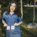 Pregnant woman with boy and girl cards near belly