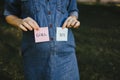 Pregnant woman with boy and girl cards near belly