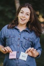 Pregnant woman with boy and girl cards near belly