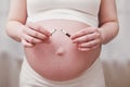 Pregnant woman breaks a cigarette in her hands as smoking cessation Royalty Free Stock Photo