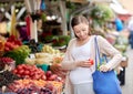 Pregnant woman buying food at street market Royalty Free Stock Photo