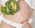 Pregnant woman with cabbage