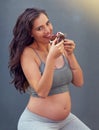 Pregnant woman, cake and portrait in studio for craving dessert, maternity and prenatal overeating in pregnancy. Mother