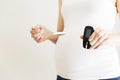 Pregnant woman checking blood sugar level. Gestational diabetes. Royalty Free Stock Photo