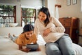 Pregnant woman, child and tablet for online learning in home bedroom for bonding, education and knowledge. Smile of kid Royalty Free Stock Photo