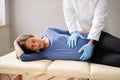 Pregnant Woman At Chiropractor. Baby Breech Physiotherapy