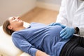 Pregnant Woman At Chiropractor. Baby Breech Physiotherapy