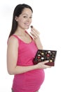 Pregnant woman with chocolates Royalty Free Stock Photo