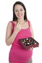 Pregnant woman with chocolates Royalty Free Stock Photo