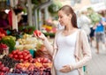 Pregnant woman choosing food at street market Royalty Free Stock Photo