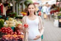 Pregnant woman choosing food at street market Royalty Free Stock Photo