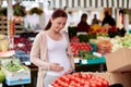 Pregnant woman choosing food at street market Royalty Free Stock Photo