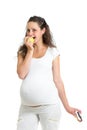 Pregnant woman choosing between healthy food fruits and cake iso Royalty Free Stock Photo