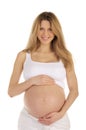 Pregnant woman clasps her hands on stomach Royalty Free Stock Photo