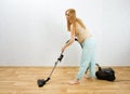 Pregnant woman cleaning floor with vacuum cleaner Royalty Free Stock Photo