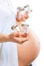 Pregnant woman with containers for urine samples