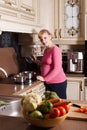 Pregnant woman is cooking Royalty Free Stock Photo