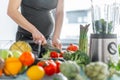 Pregnant woman cooking healthy food Royalty Free Stock Photo