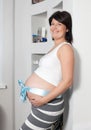 The pregnant woman costs at a wall Royalty Free Stock Photo