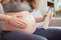 Pregnant woman on a couch in living room