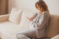 Pregnant woman counting contractions using smartphone app Royalty Free Stock Photo