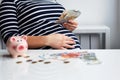 Pregnant woman counting money