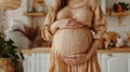 Pregnant woman cradling her belly in a warm, homely kitchen setting.