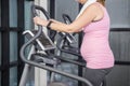 Pregnant woman on crosstrainer