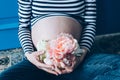 Pregnant woman cuddling belly in bedroom at home just before the labor and childbirth, selective focus Royalty Free Stock Photo