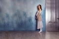 Pregnant woman dancer. Blue wall. Copy space. Royalty Free Stock Photo