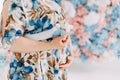 Pregnant woman in delicate blue dress stroking her belly Royalty Free Stock Photo