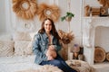 pregnant woman in denim jacket with naked tummy sitting in bed Royalty Free Stock Photo