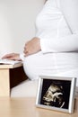 Pregnant woman at desk - ultrasound Royalty Free Stock Photo