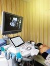 Pregnant woman at the doctor. Ultrasound diagnostic machine.