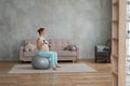 Pregnant woman doing exercises with dumbbells while sitting on a fitness ball at home. Royalty Free Stock Photo